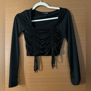 Black Fashion Nova ruffled long sleeve top in great condition. Size small.